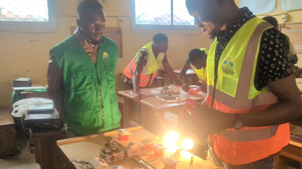 Workshop participants learning about solar panel installation
